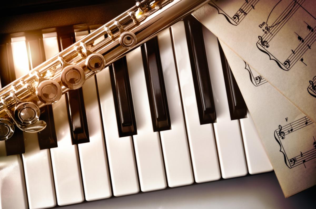 Close up of piano, flute and sheet music