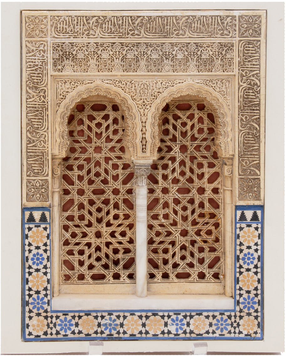 3-D sculpture of two arches with column in the middle, with ornate design to the top and tiled design on the bottom third.